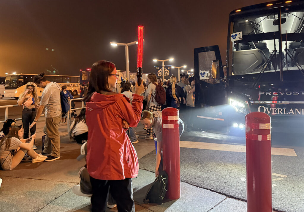 A SBNYC Red Jacket team member loading a student bus in at Orlando.